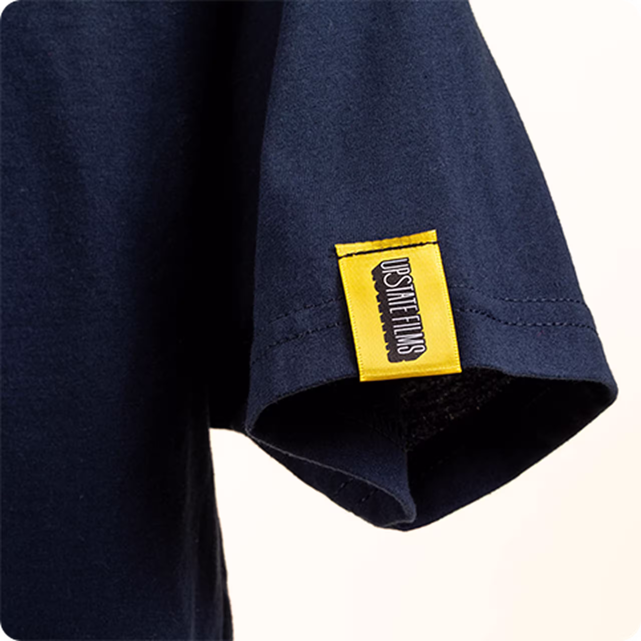 close up of a yellow hem tag on a navy shirt
