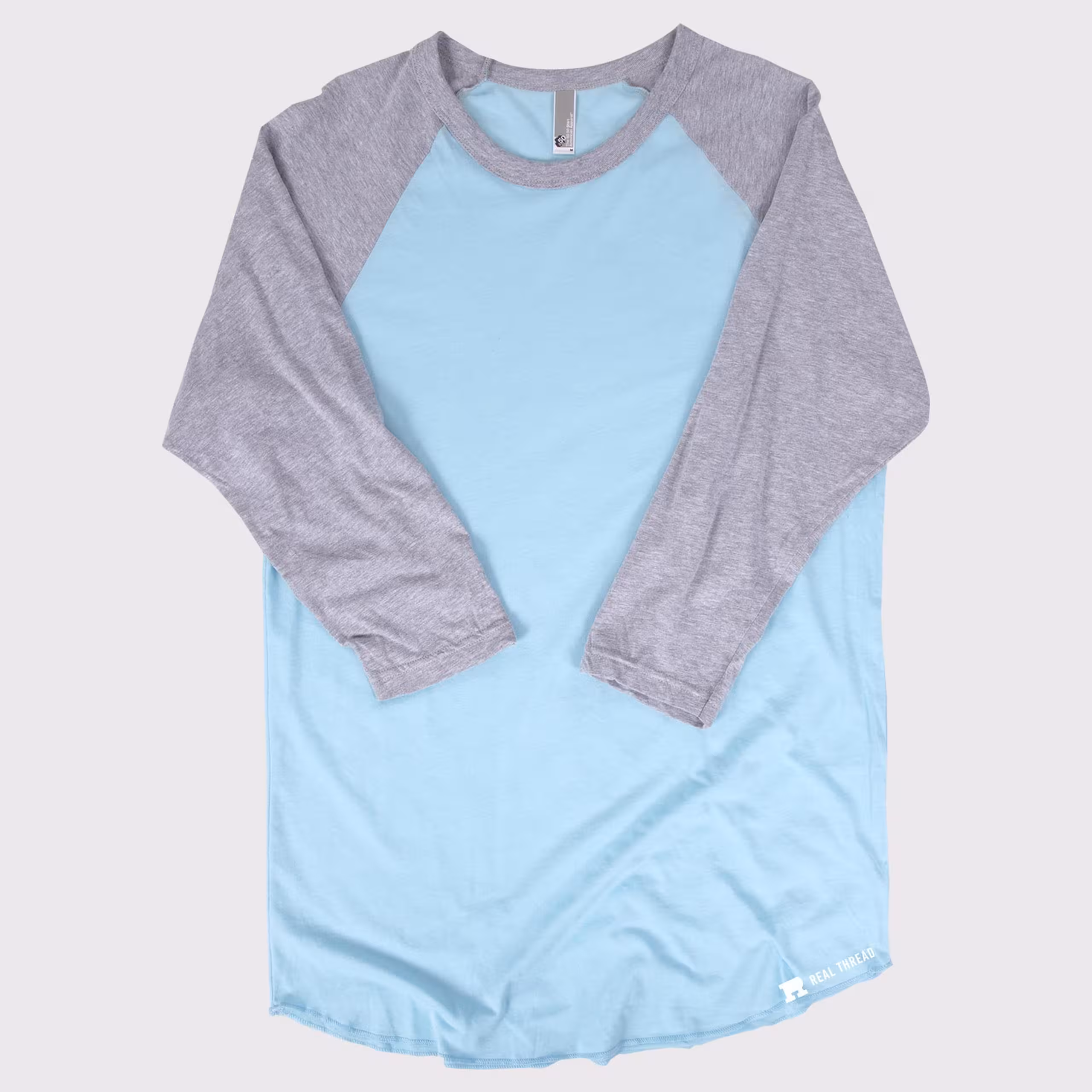 three quarter length sleeve shirt laying flat