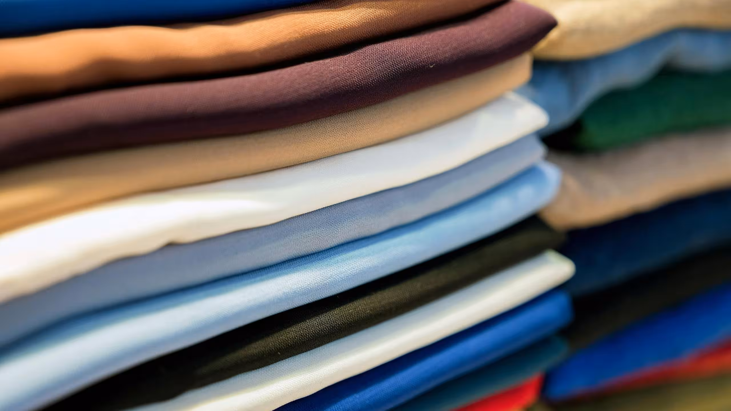 stack of t-shirts of different colors