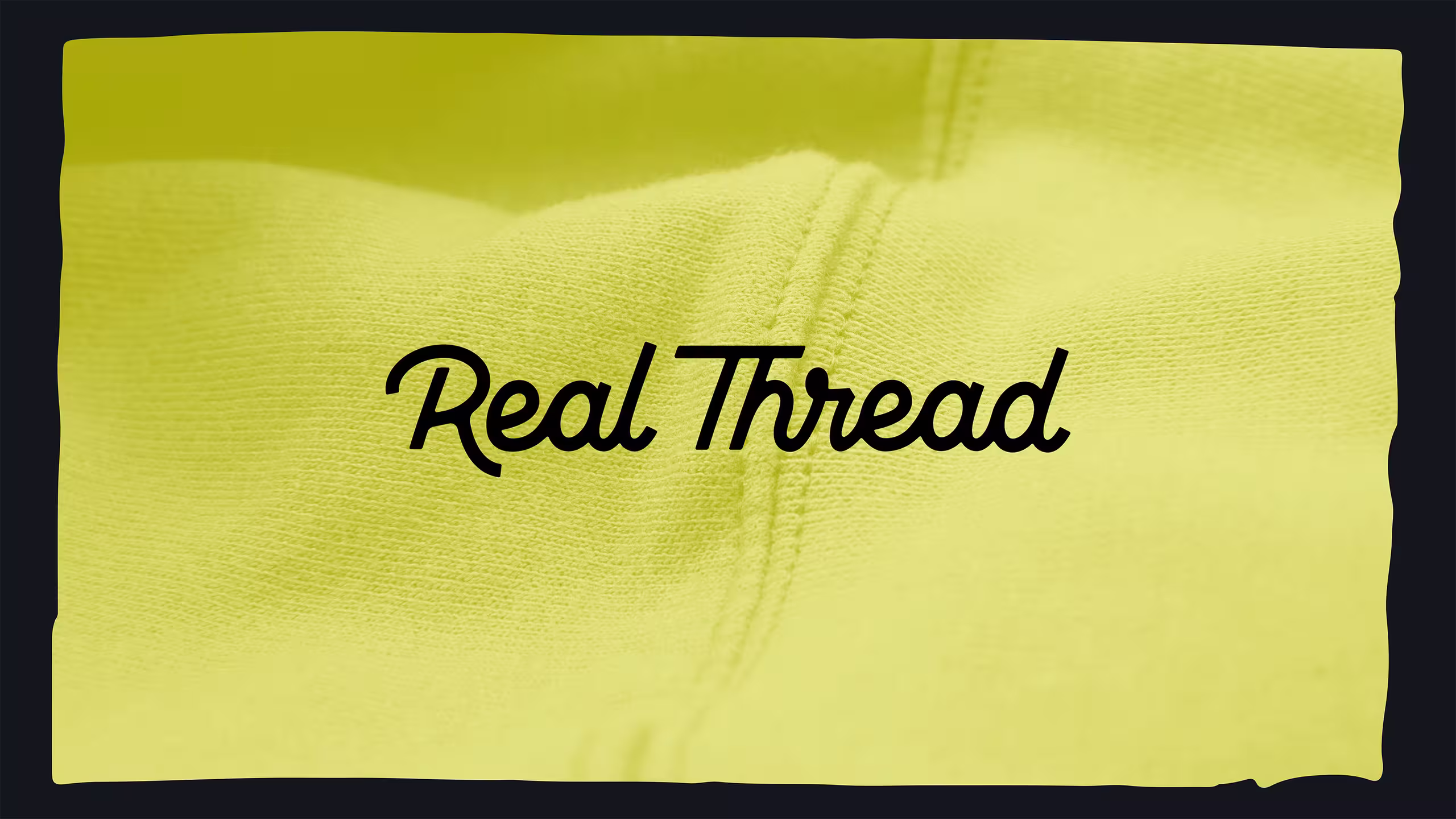 close up of yellow sweatshirt with real thread logo