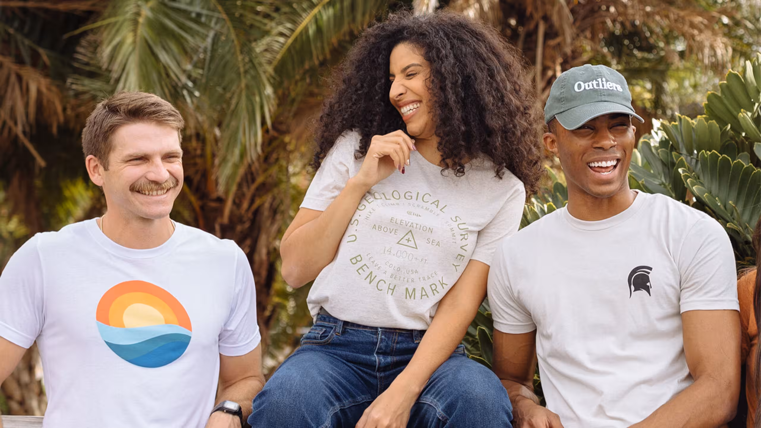 three people wearing white t-shirts with different designs on them
