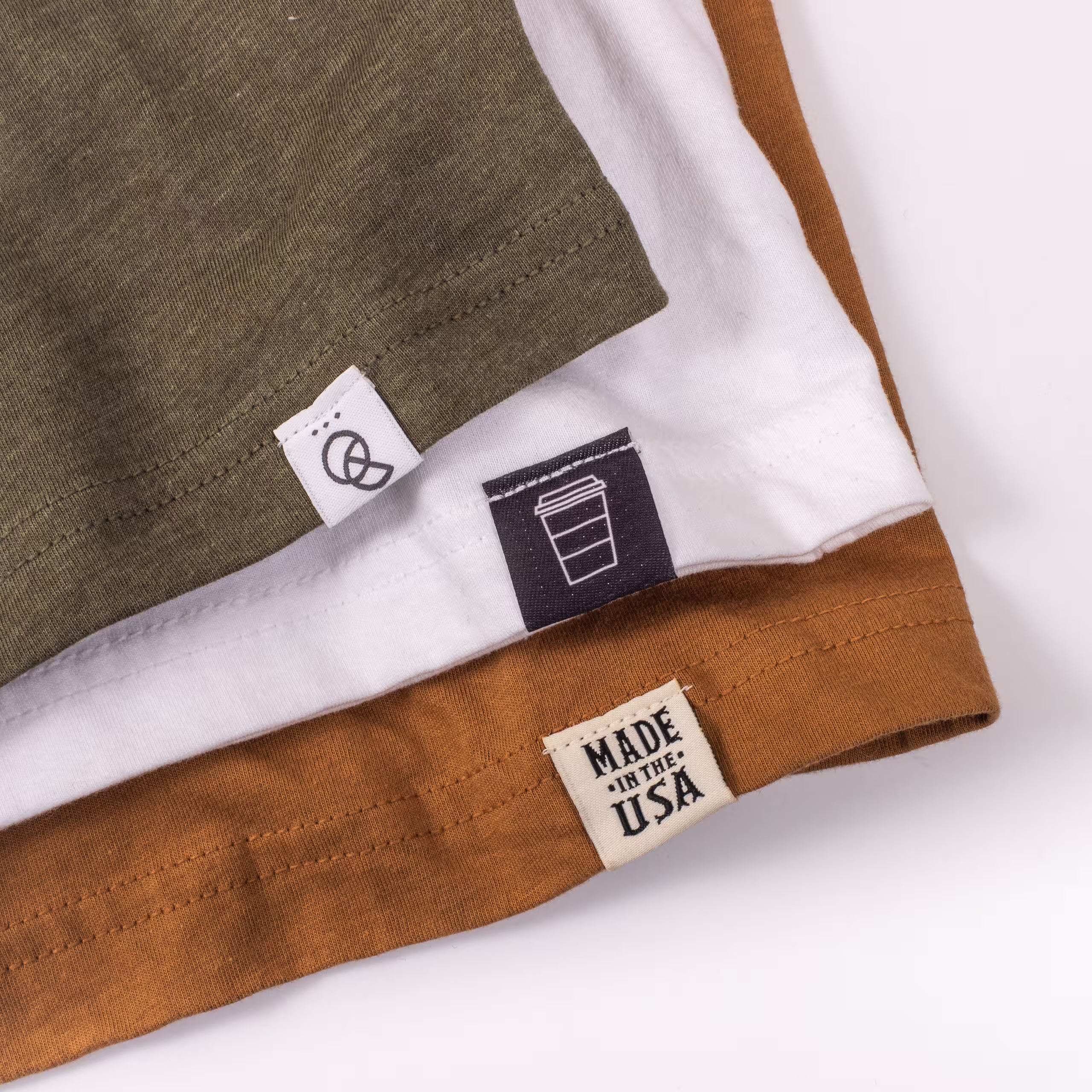 Three shirts with hem tags stacked up