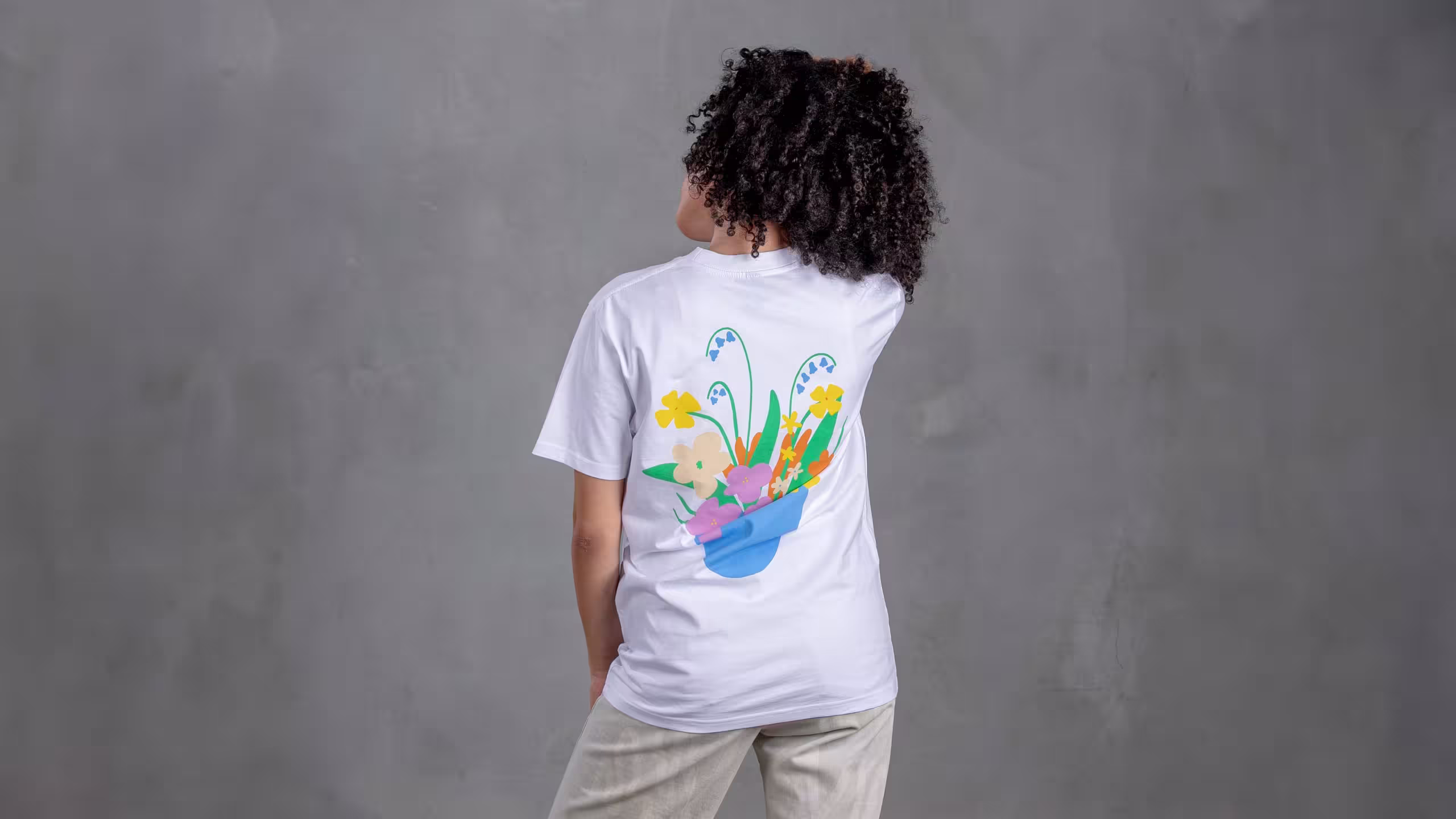 women wearing a white shirt in front of a grey wall