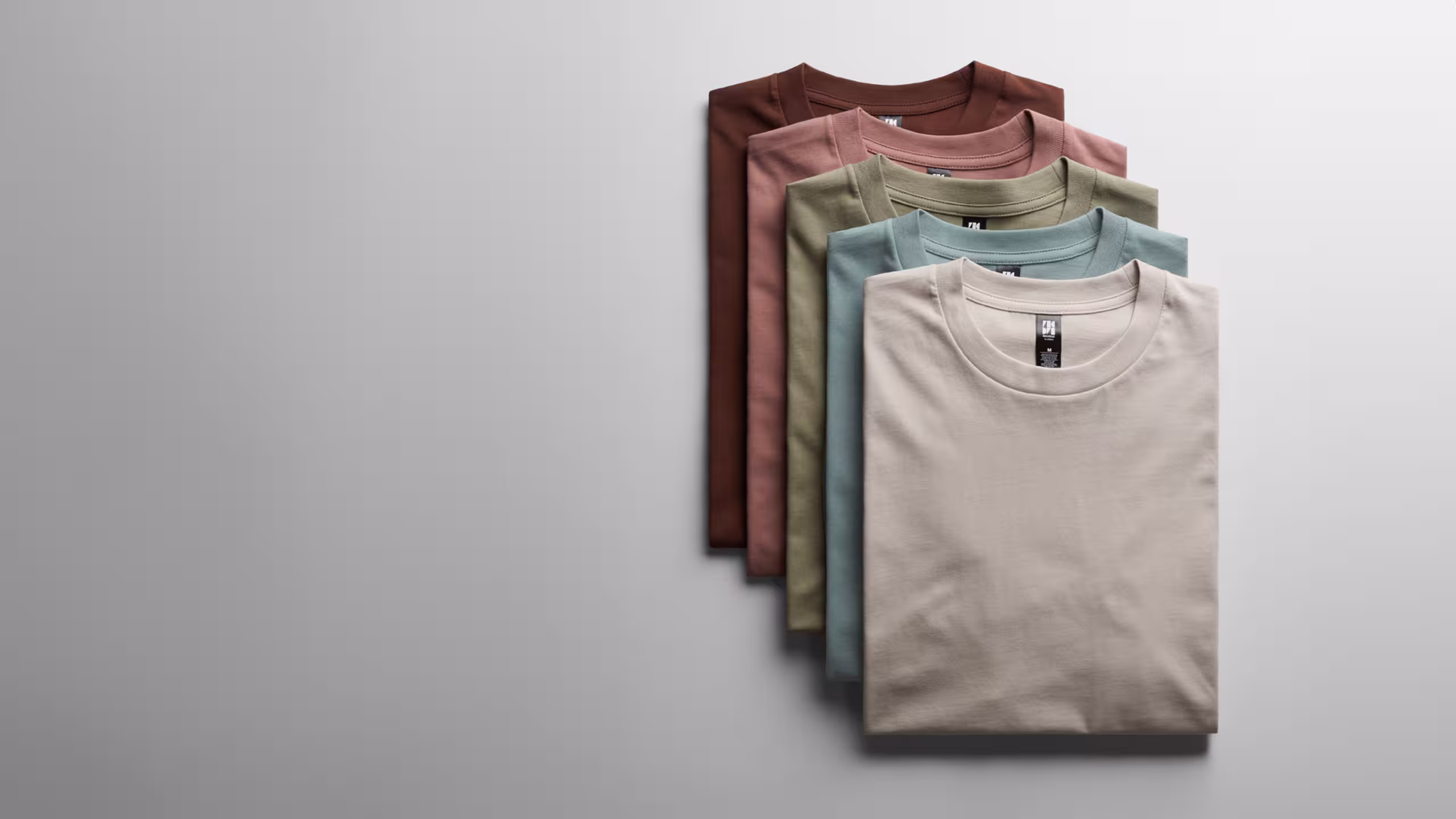 stack of folded as colour t-shirts