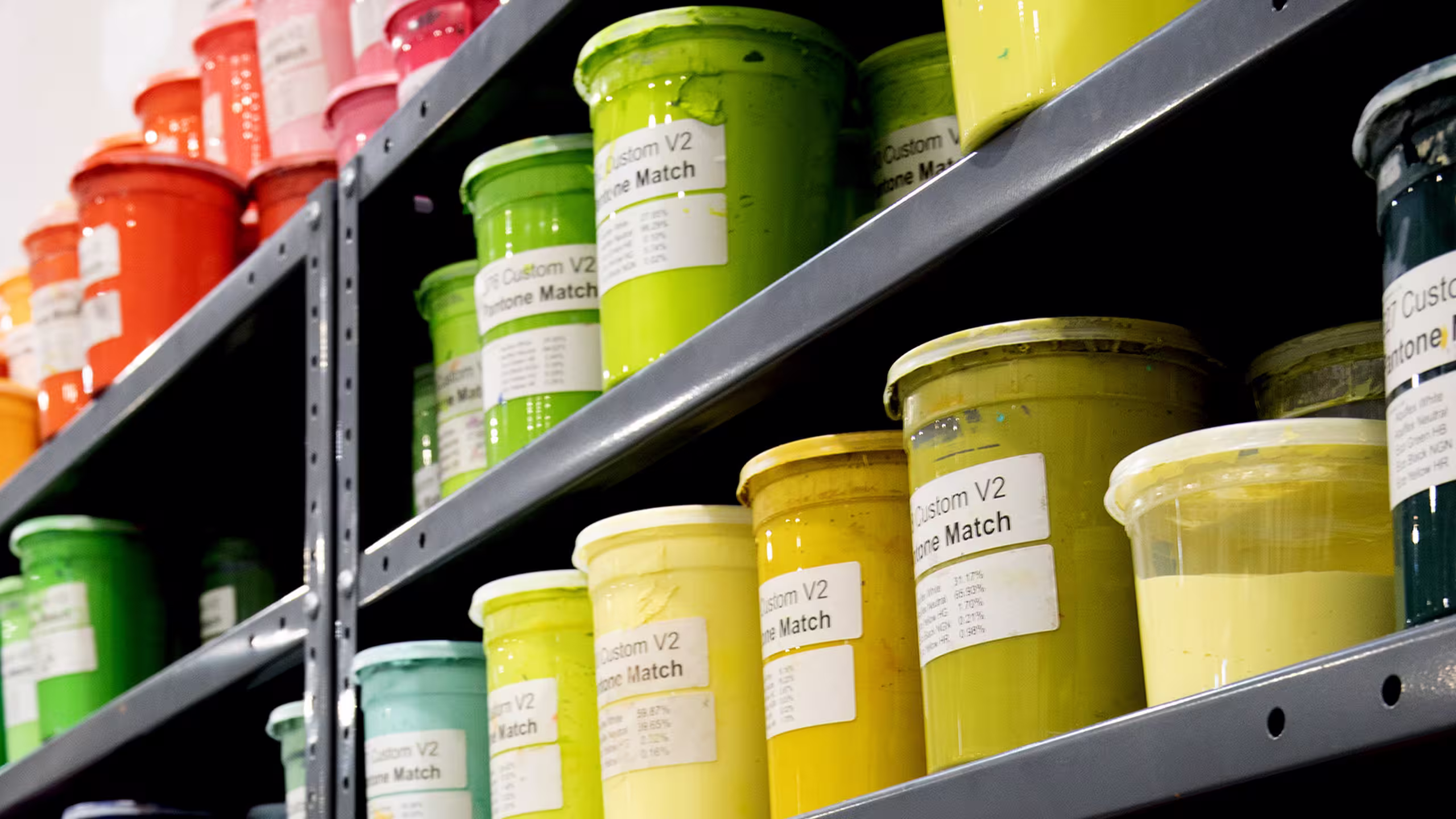 yellow, green, and orange inks on a shelf